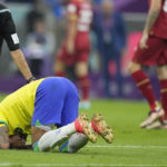 
              Brazil's Neymar kneels on the pitch during the World Cup group G soccer match between Brazil and Serbia, at the Lusail Stadium in Lusail, Qatar, Thursday, Nov. 24, 2022. (AP Photo/Aijaz Rahi)
            