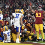 
              Southern California tight end Josh Falo signals touchdown after quarterback Caleb Williams, under the pile, scored against California during the first quarter of an NCAA college football game Saturday, Nov. 5, 2022, in Los Angeles. (AP Photo/John McCoy)
            