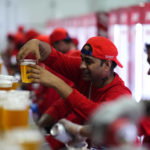 Staff member holds a beer at a fan zone ahead of the FIFA World Cup, in Doha, Qatar Saturday, Nov. 19, 2022. (AP Photo/)