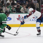 
              Dallas Stars defenseman Colin Miller (6) defends as Colorado Avalanche center Nathan MacKinnon (29) positions to take a shot in the second period of an NHL hockey game Monday, Nov. 21, 2022, in Dallas. (AP Photo/Tony Gutierrez)
            