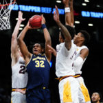 Michigan's Tarris Reed Jr. (32) drives past Arizona State's Duke Brennan (24) during the first half of an NCAA college basketball game in the championship round of the Legends Classic Thursday, Nov. 17, 2022, in New York. (AP Photo/Frank Franklin II)