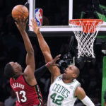 
              Boston Celtics center Al Horford (42) reaches to block a shot by Miami Heat center Bam Adebayo (13) during the first half of an NBA basketball game Wednesday, Nov. 30, 2022, in Boston. (AP Photo/Charles Krupa)
            