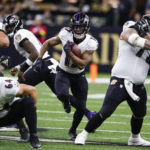Baltimore Ravens running back Kenyan Drake, center, runs with the ball in the first half of an NFL football game against the New Orleans Saints in New Orleans, Monday, Nov. 7, 2022. (AP Photo/Butch Dill)
