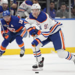 
              Edmonton Oilers center Connor McDavid (97) skates the puck up the ice in the first period of an NHL hockey game against the New York Islanders, Wednesday, Nov. 23, 2022, in Elmont, N.Y. (AP Photo/John Minchillo)
            