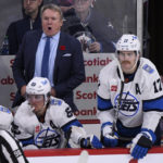 Winnipeg Jets head coach Rick Bowness shouts instructions to his team as Adam Lowry (17) looks to get on the ice against the Chicago Blackhawks during the third period of an NHL hockey game in Winnipeg, Manitoba, Saturday, Nov. 5, 2022. (Fred Greenslade/The Canadian Press via AP)