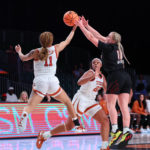 
              In a photo provided by Bahamas Visual Services, Texas' Sonya Morris (11) goes against Louisville's Hailey Van Lith (10) during an NCAA college basketball game in the Battle 4 Atlantis at Paradise Island, Bahamas, Sunday, Nov. 20, 2022. (Tim Aylen/Bahamas Visual Services via AP)
            