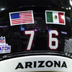 
              FILE -  Arizona Cardinals' Will Hernandez wears a United States flag and a Mexican flag on his helmet before the first half of an NFL football game against the Philadelphia Eagles, Sunday, Oct. 9, 2022, in Glendale, Ariz. The NFL returns to Mexico City on Monday, Nov. 21, 2022, when Arizona Cardinals play the San Francisco 49ers. The Cardinals have two Latino players on the roster — Max Garcia and Will Hernandez.  (AP Photo/Darryl Webb, File)
            