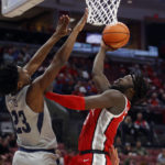 
              Ohio State guard Isaac Likekele, right, goes up to shoot in front of Robert Morris guard Chris Ford during the second half of an NCAA college basketball game in Columbus, Ohio, Monday, Nov. 7, 2022. (AP Photo/Paul Vernon)
            