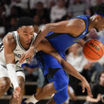 Vanderbilt guard Tyrin Lawrence, left, and Memphis forward DeAndre Williams battle for the ball in the second half of an NCAA college basketball game Monday, Nov. 7, 2022, in Nashville, Tenn. (AP Photo/Mark Humphrey)