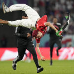 
              A pitch invader jumps during a World Cup group D soccer match between Tunisia and France at the Education City Stadium in Al Rayyan, Qatar, Wednesday, Nov. 30, 2022. (AP Photo/Martin Meissner)
            