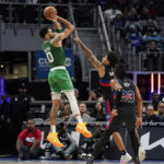 Boston Celtics forward Jayson Tatum (0) shoots over the defense of Detroit Pistons guard Killian Hayes during the second half of an NBA basketball game, Saturday, Nov. 12, 2022, in Detroit. (AP Photo/Carlos Osorio)