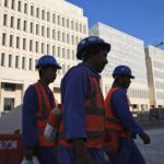 
              FILE- Workers leave their construction sites at the Msheireb Downtown Doha district in Doha, Qatar on April 23, 2019. Qatar is home to roughly 2.6 million people, but a tiny fraction of that — around 12% — are Qatari citizens. They enjoy massive wealth and benefits fueled by Qatar's shared control of one of the world's largest reserves of natural gas. (AP Photo/Kamran Jebreili, File)
            