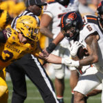 Oregon State running back Damien Martinez (6) runs with the ball as Arizona State linebacker Kyle Soelle, left, closes in during the first half of an NCAA college football game in Tempe, Ariz., Saturday, Nov. 19, 2022. (AP Photo/Ross D. Franklin)