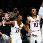 Arizona State's DJ Horne (0) and Frankie Collins (10) cheer for their teammates during the second half of an NCAA college basketball game against Michigan in the championship round of the Legends Classic Thursday, Nov. 17, 2022, in New York. Arizona State won 87-62. (AP Photo/Frank Franklin II)