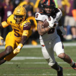 Oregon State running back Damien Martinez (6) runs past Arizona State defensive back Chris Edmonds (5) during the first half of an NCAA college football game in Tempe, Ariz., Saturday, Nov. 19, 2022. (AP Photo/Ross D. Franklin)