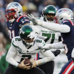 
              New York Jets quarterback Zach Wilson (2) is sacked by New England Patriots defensive end Deatrich Wise Jr. (91) and linebacker Josh Uche (55) during the second half of an NFL football game, Sunday, Nov. 20, 2022, in Foxborough, Mass. (AP Photo/Michael Dwyer)
            