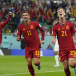Spain's Dani Olmo, right, with teammate Ferran Torres, middle, and Gavi celebrates after scoring his side's first goal during the World Cup group E soccer match between Spain and Costa Rica, at the Al Thumama Stadium in Doha, Qatar, Wednesday, Nov. 23, 2022. (AP Photo/Julio Cortez)