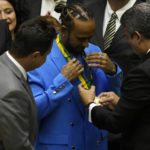 
              British Mercedes Formula One driver Lewis Hamilton receives a medal as he is given the title of Honorary Citizen of Brazil during a ceremony at the Chamber of Deputies in Brasilia, Brazil, Monday, Nov. 7, 2022. (AP Photo/Eraldo Peres)
            
