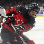 
              Canada's Claire Thompson (42) works along the boards next to a U.S. player during the first period of a Rivalry Series hockey game Thursday, Nov. 17, 2022, in Kamloops, British Columbia. (Jesse Johnston/The Canadian Press via AP)
            