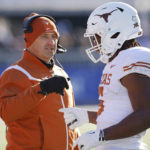 
              Texas head coach Steve Sarkisian, left, congratulates running back Bijan Robinson (5) after scoring a touchdown during the first quarter of an NCAA college football game against Kansas, Saturday, Nov. 19, 2022, in Lawrence, Kan. (AP Photo/Colin E. Braley)
            