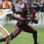 
              South Carolina tight end Jaheim Bell (0) stiff-arms Tennessee defensive back Tamarion McDonald (12) during the second half of an NCAA college football game Saturday, Nov. 19, 2022, in Columbia, S.C. (AP Photo/Artie Walker Jr.)
            