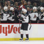 
              Arizona Coyotes defenseman J.J. Moser (90) is congratulated for his goal against the Minnesota Wild during the third period of an NHL hockey game Sunday, Nov. 27, 2022, in St. Paul, Minn. (AP Photo/Stacy Bengs)
            
