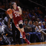 FILE - Indiana forward Mackenzie Holmes (54) saves the ball from going out of bounds during the second half of the tema's NCAA college basketball game against Tennessee, Nov. 14, 2022, in Knoxville, Tenn. Five players, including Grace Berger, are averaging at least 10 points. The group is led by 6-foot-3 forward Holmes (20.0), a two-time all-conference selection coming off an injury-plagued 2021-22. (AP Photo/Wade Payne, File)