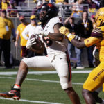 Oregon State running back Damien Martinez (6) scores a touchdown as he gets past Arizona State defensive back Chris Edmonds (5) during the first half of an NCAA college football game in Tempe, Ariz., Saturday, Nov. 19, 2022. (AP Photo/Ross D. Franklin)