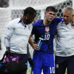 
              Christian Pulisic of the United States is helped off the pitch after suffering an injury during the World Cup group B soccer match between Iran and the United States at the Al Thumama Stadium in Doha, Qatar, Tuesday, Nov. 29, 2022. (AP Photo/Manu Fernandez)
            