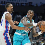 
              Charlotte Hornets guard Terry Rozier, right, looks to pass around the defense of Philadelphia 76ers guard De'Anthony Melton, left, during the first half of an NBA basketball game Wednesday, Nov. 23, 2022, in Charlotte, N.C. (AP Photo/Rusty Jones)
            