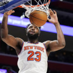 New York Knicks center Mitchell Robinson dunks during the second half of an NBA basketball game against the Detroit Pistons, Tuesday, Nov. 29, 2022, in Detroit. (AP Photo/Carlos Osorio)