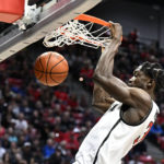 
              San Diego State forward Nathan Mensah dunks during the first half of an NCAA college basketball game against Cal State Fullerton, Monday, Nov. 7, 2022, in San Diego. (AP Photo/Denis Poroy)
            