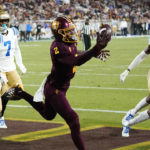 Arizona State wide receiver Elijhah Badger (2) makes a one-handed touchdown catch between UCLA defensive backs Kenny Churchwell III (23), Mo Osling III (7), and John Humphrey (6) during the second half of an NCAA college football game in Tempe, Ariz., Saturday, Nov. 5, 2022. UCLA won 50-36. (AP Photo/Ross D. Franklin)