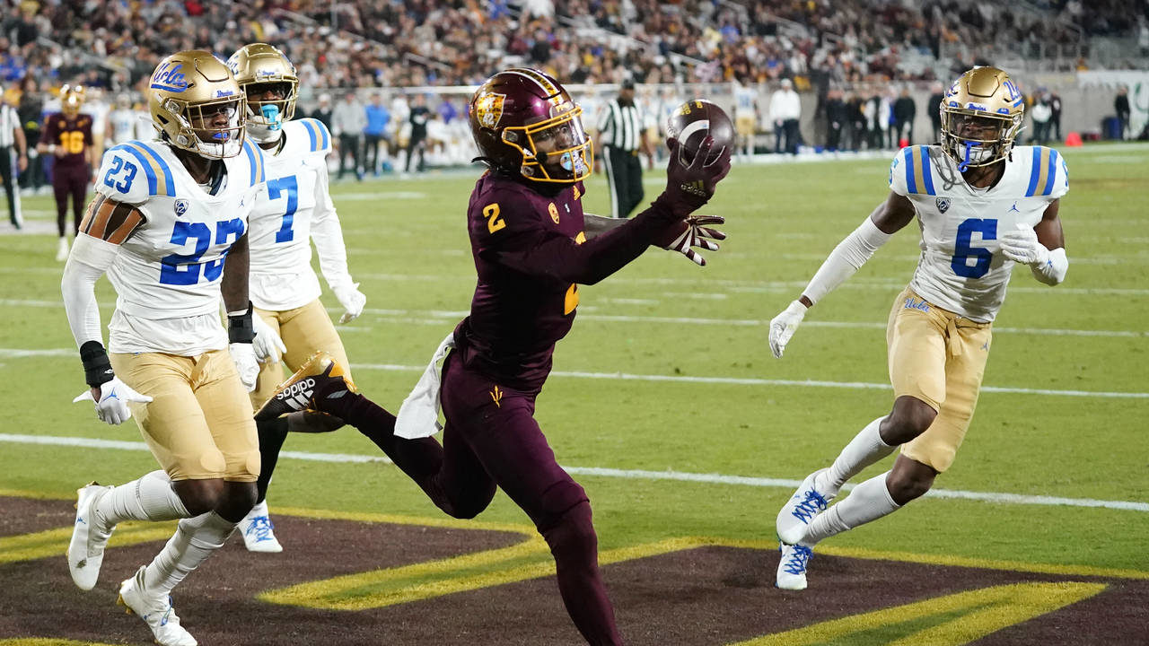 Arizona State wide receiver Elijhah Badger (2) makes a one-handed touchdown catch between UCLA defe...