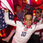 
              People dance during an official U.S. Soccer fan party at the Budweiser World Club ahead of a FIFA World Cup group B soccer match between the United States and Wales, in Doha, Sunday, Nov. 20, 2022. (AP Photo/Ashley Landis)
            