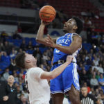Duke guard Jeremy Roach, right, shoots over Oregon State guard Nick Krass during the first half of an NCAA college basketball game in the Phil Knight Legacy tournament in Portland, Ore., Thursday, Nov. 24, 2022. (AP Photo/Craig Mitchelldyer)