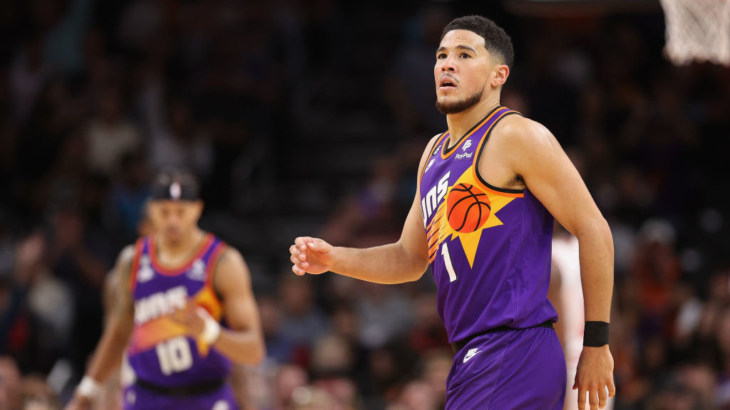 Devin Booker #1 of the Phoenix Suns reacts after a three-point shot against the Chicago Bulls durin...