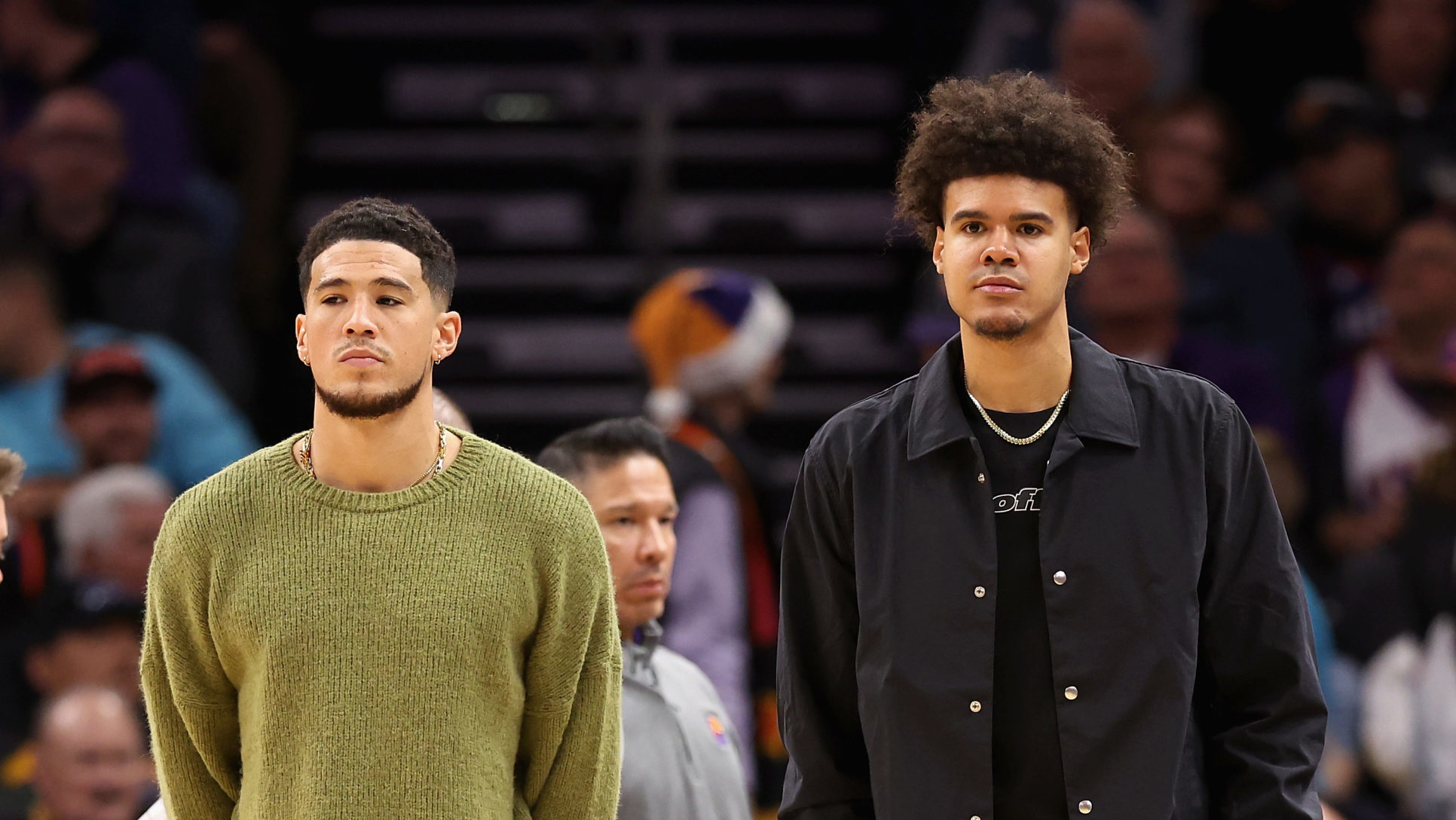 Devin Booker #1 and Cameron Johnson #23 of the Phoenix Suns watch from the bench during the second ...