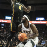 
              Appalachian State guard Xavion Brown (0) applies pressure to Wake Forest guard Jao Ituka (10) in the first half of an NCAA college basketball game on Wednesday, Dec. 14, 2022, at Joel Coliseum in Winston-Salem, N.C. (Allison Lee Isley/The Winston-Salem Journal via AP)
            