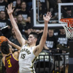 Minnesota forward Dawson Garcia (3) attempts to shoot while defended by Purdue center Zach Edey (15) during the second half of an NCAA college basketball game, Sunday, Dec. 4, 2022, in West Lafayette, Ind. (AP Photo/Doug McSchooler)