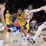 Iowa's Ahron Ulis (1) drives past Duke's Jeremy Roach (3) during the second half of an NCAA college basketball game in the Jimmy V Classic, Tuesday, Dec. 6, 2022, in New York. (AP Photo/John Minchillo)