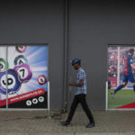 
              A man leaves the building of a sports betting shop in the Soweto township of Johannesburg, South Africa Thursday, Dec. 8, 2022. Although sports betting is a global phenomenon and a legitimate business in many countries, the stakes are high on the continent of 1.3 billion people because of lax or non-existent regulation, poverty and widespread unemployment. (AP Photo/Denis Farrell)
            