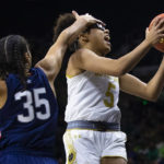 Notre Dame's Olivia Miles (5) tries to drive past Connecticut's Azzi Fudd (35) during the first half of an NCAA college basketball game on Sunday, Dec. 4, 2022, in South Bend, Ind. (AP Photo/Michael Caterina)
