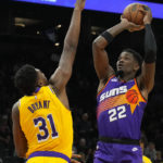 Phoenix Suns center Deandre Ayton shoots over Los Angeles Lakers center Thomas Bryant (31) during the second half of an NBA basketball game, Monday, Dec. 19, 2022, in Phoenix. (AP Photo/Rick Scuteri)