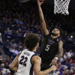 
              Washington guard Jamal Bey (5) shoots while defended. by Gonzaga forward Anton Watson (22) during the first half of an NCAA college basketball game, Friday, Dec. 9, 2022, in Spokane, Wash. (AP Photo/Young Kwak)
            