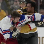 
              New York Rangers center Barclay Goodrow (21) and Vegas Golden Knights right wing Keegan Kolesar (55) fight during the second period of an NHL hockey game Wednesday, Dec. 7, 2022, in Las Vegas. (AP Photo/John Locher)
            