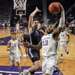 Kansas State guard Desi Sills (13) gets past Abilene Christian guard Tobias Cameron (11) to put up a shot during the second half of an NCAA college basketball game Tuesday, Dec. 6, 2022, in Manhattan, Kan. Kansas State won 81-64. (AP Photo/Charlie Riedel)
