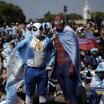 
              Argentina soccer fans dressed as superheroes watch their team's World Cup semifinal match against Croatia, hosted by Qatar, on a screen set up in the Palermo neighborhood of Buenos Aires, Argentina, Tuesday, Dec.13, 2022. (AP Photo/Rodrigo Abd)
            
