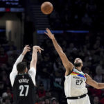 
              Portland Trail Blazers center Jusuf Nurkic, left, hits a shot over Minnesota Timberwolves center Rudy Gobert during the first half of an NBA basketball game in Portland, Ore., Saturday, Dec. 10, 2022. (AP Photo/Steve Dykes)
            