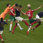 
              Morocco's Jawad El Yamiq, second right, fights for the ball with France's Raphael Varane, third right, and Randal Kolo Muani, right, during the World Cup semifinal soccer match between France and Morocco at the Al Bayt Stadium in Al Khor, Qatar, Wednesday, Dec. 14, 2022. (AP Photo/Thanassis Stavrakis)
            